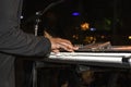 Black man in black suit playing the keyboard at night with bokeh background - movement blur Royalty Free Stock Photo