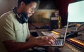 Black man, thinking and laptop for music recording, sound engineering or song composition in studio. Producer, DJ and Royalty Free Stock Photo