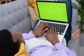 Black man using laptop notebook viewing green screen press keyboard browsing chroma key, African American freelancer Royalty Free Stock Photo