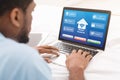 Black Man Using Laptop With Smart Home Control System On Screen, Collage Royalty Free Stock Photo