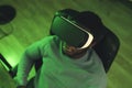 black man sitting VR game neon lights - portrait shot