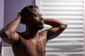 Black man washing head with shampoo in shower Royalty Free Stock Photo