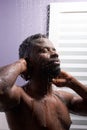 Black man washing head with shampoo in shower Royalty Free Stock Photo