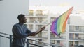Black man waving rainbow flag. Sexual identity and equal treatmant concept