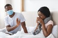 Black man wearing face mask while his wife is sick