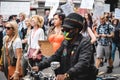 Black man wearing mask on bike at Save Our Children Protest against Children Trafficking Royalty Free Stock Photo