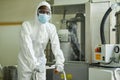 Black man wearing mask and protective suit at pharmaceutical factory Royalty Free Stock Photo