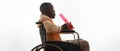 Black man on wheelchair light bong with marijuana