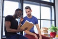 A black man and white guy readiing a book. Royalty Free Stock Photo