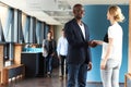 Black man and white woman smiling and shaking hands Royalty Free Stock Photo