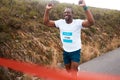 Black man, winner of race and fitness with cheers, athlete and sports with running in street and competition. Marathon