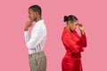 Black man and woman in deep thought, turned away, standing back to back Royalty Free Stock Photo