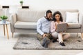 Black man and woman having videocall using laptop waving hand Royalty Free Stock Photo