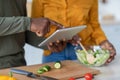 Black Man And Woman Using Digital Tablet While Cooking Lunch In Kitchen Royalty Free Stock Photo
