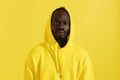 Black man in yellow hoodie with shocked face, colorful portrait