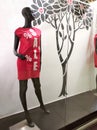 A black mannequin in a red dress with the inscription Sale on the window of the clothing store. Discounts and promotions in the Royalty Free Stock Photo