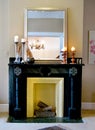 Black mantle with mirror & candlesticks Royalty Free Stock Photo