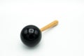 A black maracas lying on a white underground Royalty Free Stock Photo