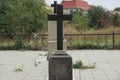 Black marble cross on the monument at the grave in the cemetery