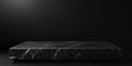 A black marble display platform sitting on a dark backdrop Royalty Free Stock Photo