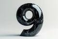 A black marble with a hole in the middle and the number nine on it Royalty Free Stock Photo