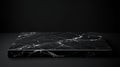 A black marble platform rests against a dark background setting Royalty Free Stock Photo