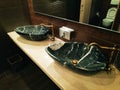 Black marble sink and faucet in bathroom, washroom, toilet.