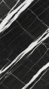 Black marble surface featuring diagonal white veining. The pattern consists of sharp, irregular Royalty Free Stock Photo