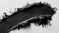A black mascara circular texture with brush strokes is on a white background.