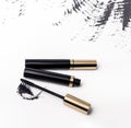 Black mascara tube and stroke isolated  white Royalty Free Stock Photo