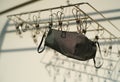 Black mask cloth hung in the clothes line in the evening sun Royalty Free Stock Photo