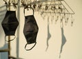 Black mask cloth hung in the clothes line in the evening sun with shadow Royalty Free Stock Photo