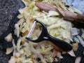 Plastic potato peeler with fresh white potato peelings