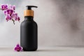 Black matte bottle with a wooden pump cap and vibrant purple orchid flower for spa-like atmosphere