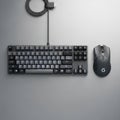 Black mechanical keyboard and wireless mouse on a gray surface Royalty Free Stock Photo