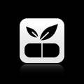 Black Medical pill with plant icon isolated on black background. Herbal pill. Silver square button. Vector