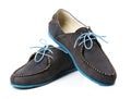 Black men's leather loafers with blue soles and laces on a white