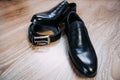 Black men's patent leather shoes for the groom and a leather black belt Royalty Free Stock Photo