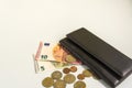 Black men`s purse. Banknotes in five and ten euros. Several coins Royalty Free Stock Photo