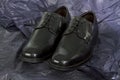 Black Mens shoes on black Paper