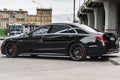 Black Mercedes AMG S63 parked along the street. Rear side view of premium sedan W222 facelift. Vehicle from German car brand Royalty Free Stock Photo