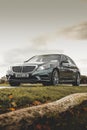 Black Mercedes Benz C-Class on a golf course against the sky