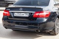 Black Mercedes Benz E-class E250 2010 year Rear view with dark gray interior and spoiler on trank in excellent condition in a Royalty Free Stock Photo