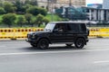 Black Mercedes-Benz G Class Gelandewagen drives down the highway. Front side view of SUV car in motion Royalty Free Stock Photo