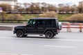 Black Mercedes-Benz G-Class moving on the street on very high speed Royalty Free Stock Photo