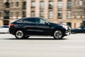 Black Mercedes Benz GLE coupe car moving on the street. Compliance with speed limits on road concept. Dynamic exterior image