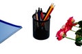 Black metal container with pens and pencils near roses isolated on a white background Royalty Free Stock Photo