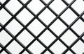 Black metal diagonal grille texture close-up. Intersecting bars form a diamond pattern, creating a strong abstract background for Royalty Free Stock Photo