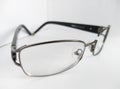 black metal eyeglasses with broken frame on white background Royalty Free Stock Photo