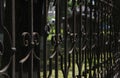 Black metal fence with monograms.